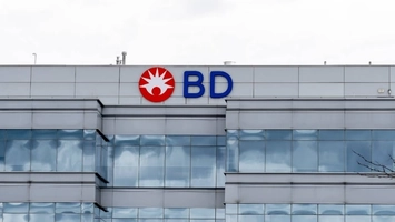 BD red starburst logo and blue company name on the upper facade of a modern silver-clad office building
